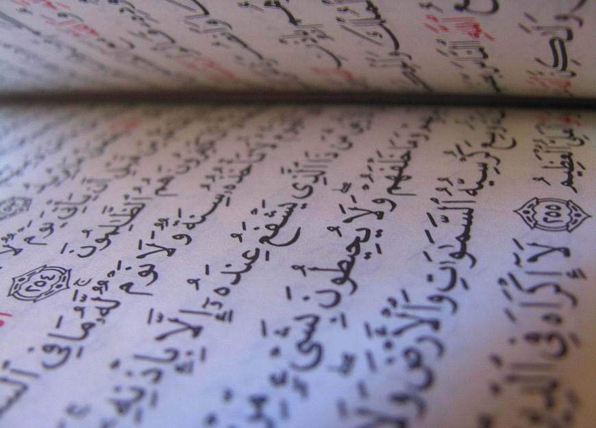 Close-up of Arabic calligraphy in an open Quran book