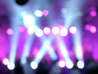 Abstract blurred stage lights with purple and white bokeh