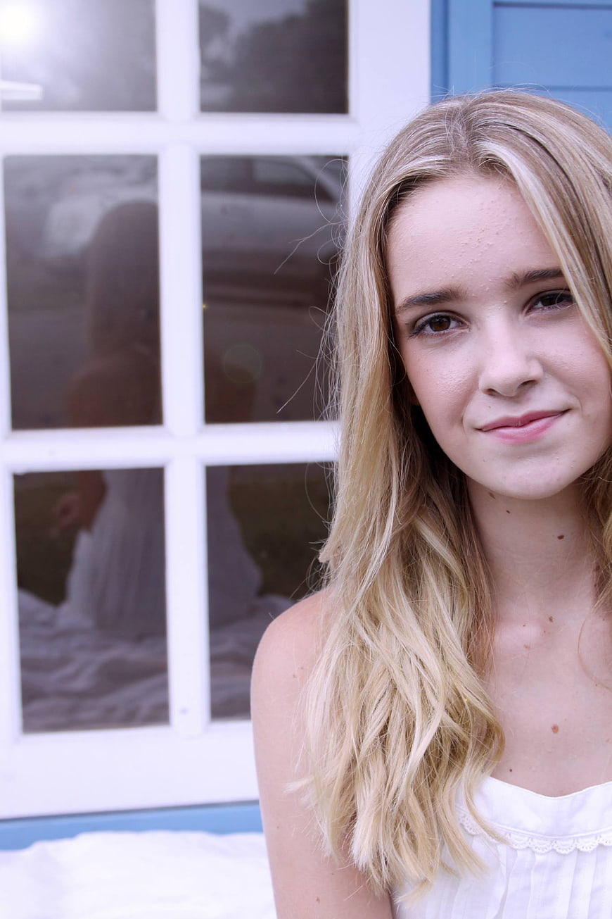 Close-up portrait of smiling blonde woman outdoors