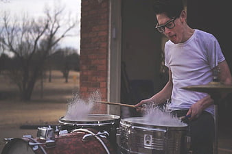 Man Playing Drums in Water Outdoors