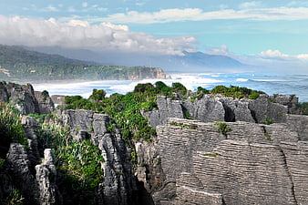 Dramatic layered rock formations overlooking ocean coastline