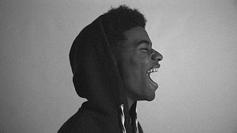 Profile of laughing man in hoodie black and white