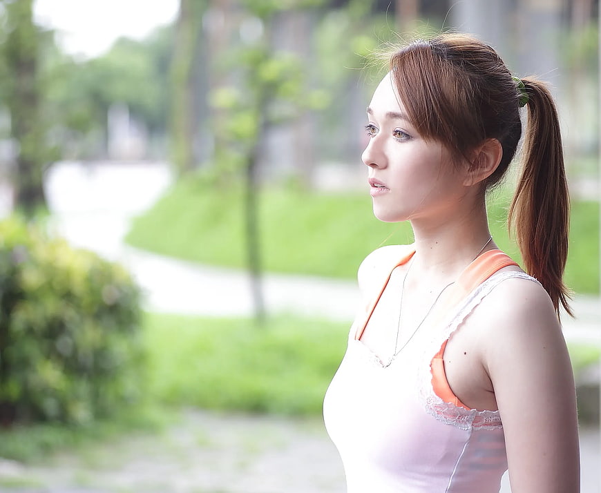 Young Woman in Park Looking Away in Profile
