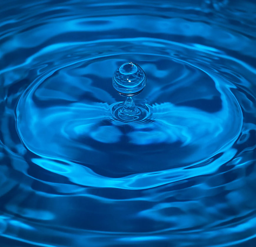 Blue water droplet splash with ripples