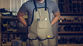 Cobbler in Apron with Tools in Workshop