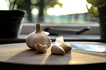Fresh Garlic Bulb and Cloves on Wooden Cutting Board