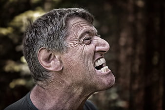 Close-up portrait of laughing senior man outdoors
