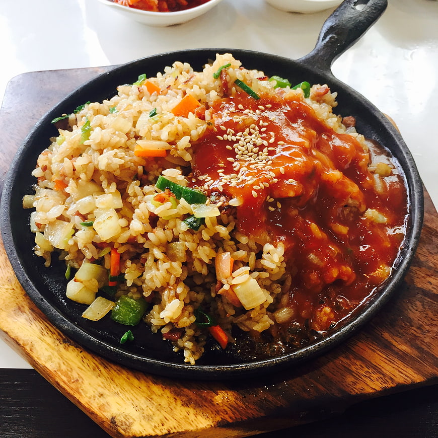 Korean fried rice with spicy sauce in cast iron skillet