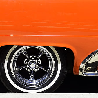 Close-up of Orange Classic Car Wheel with Chrome Rim