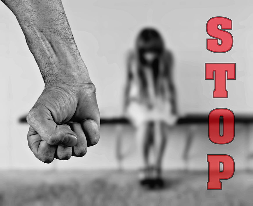 Stop Violence Against Women Fist and Blurred Girl