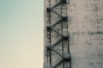Minimalist Concrete Fire Escape Stairs Against Sky