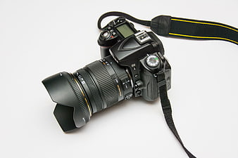 Black DSLR Camera with Lens on White Background
