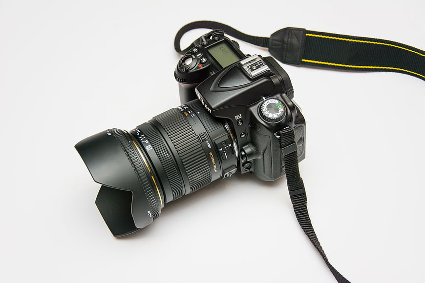 Black DSLR Camera with Lens on White Background