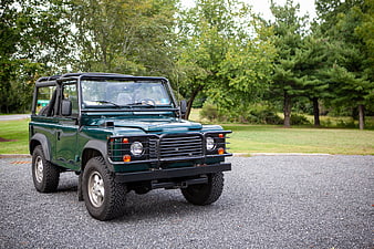 Classic Green Off-Road Vehicle Parked on Gravel