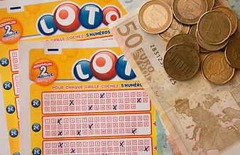 Euro banknotes and coins on French lottery tickets