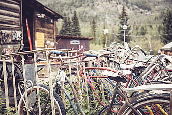 Vintage bicycles parked in a rustic mountain village setting