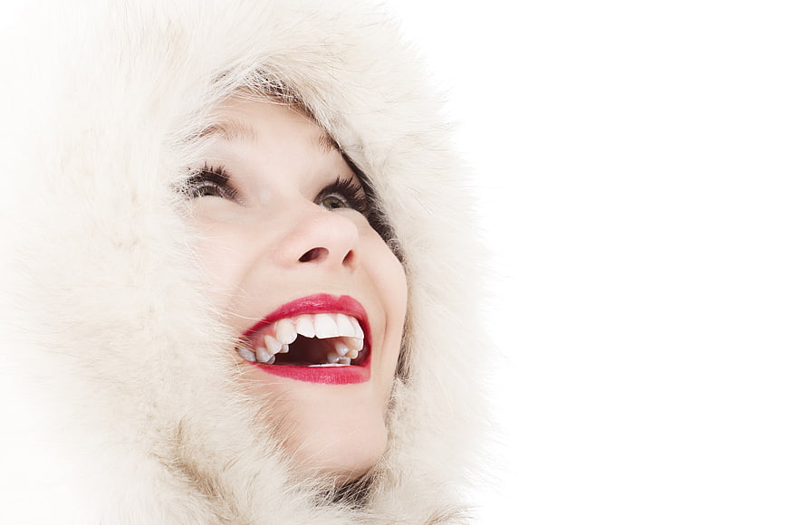 Joyful Woman in White Fur Hood Laughing Upwards
