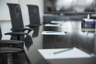 Modern conference room with notepads and pencils on table