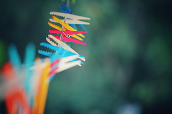 Colorful clothespins hanging on a clothesline outdoors