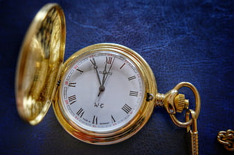 Vintage Gold Pocket Watch on Blue Leather Background