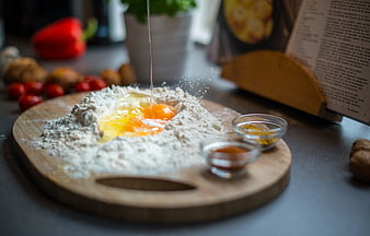 Cracking Eggs into Flour for Baking