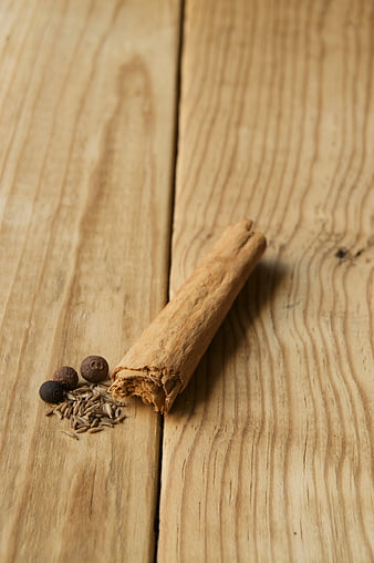 Cinnamon stick and spices on rustic wooden table background
