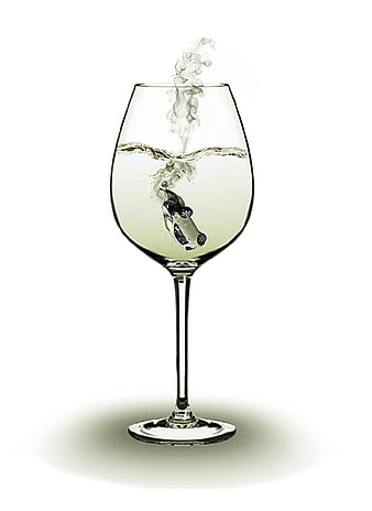 Miniature car sinking in wine glass with smoke