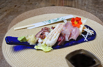 Assorted sashimi platter with octopus and fish on blue plate