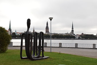 Abstract Sculpture by River with Tallinn Skyline