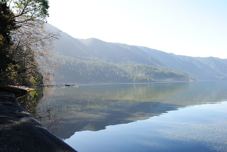 Serene Lake View with Forested Mountains and Wooden Dock