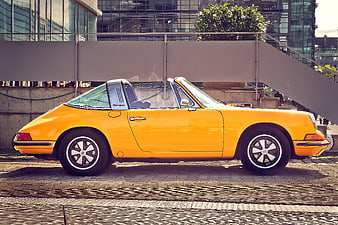 Side Profile Of A Yellow Vintage Porsche 911 Targa Parked On A Street