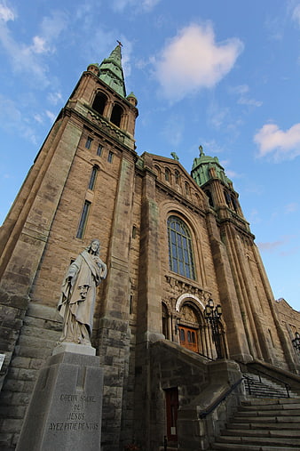 Low angle view of historic stone cathedral with statue