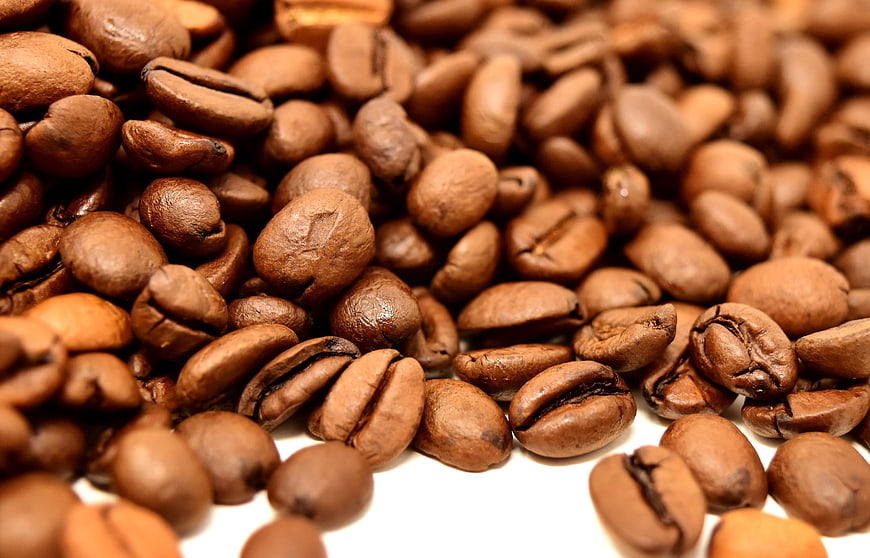 Close-up of roasted coffee beans on white background