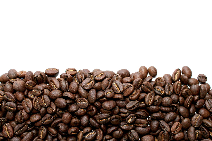 Roasted Coffee Beans Pile On White Background With Copy Space