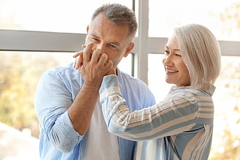 Senior couple sharing a tender kiss indoors
