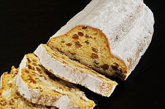 Sliced Raisin Bread with Powdered Sugar on Dark Background