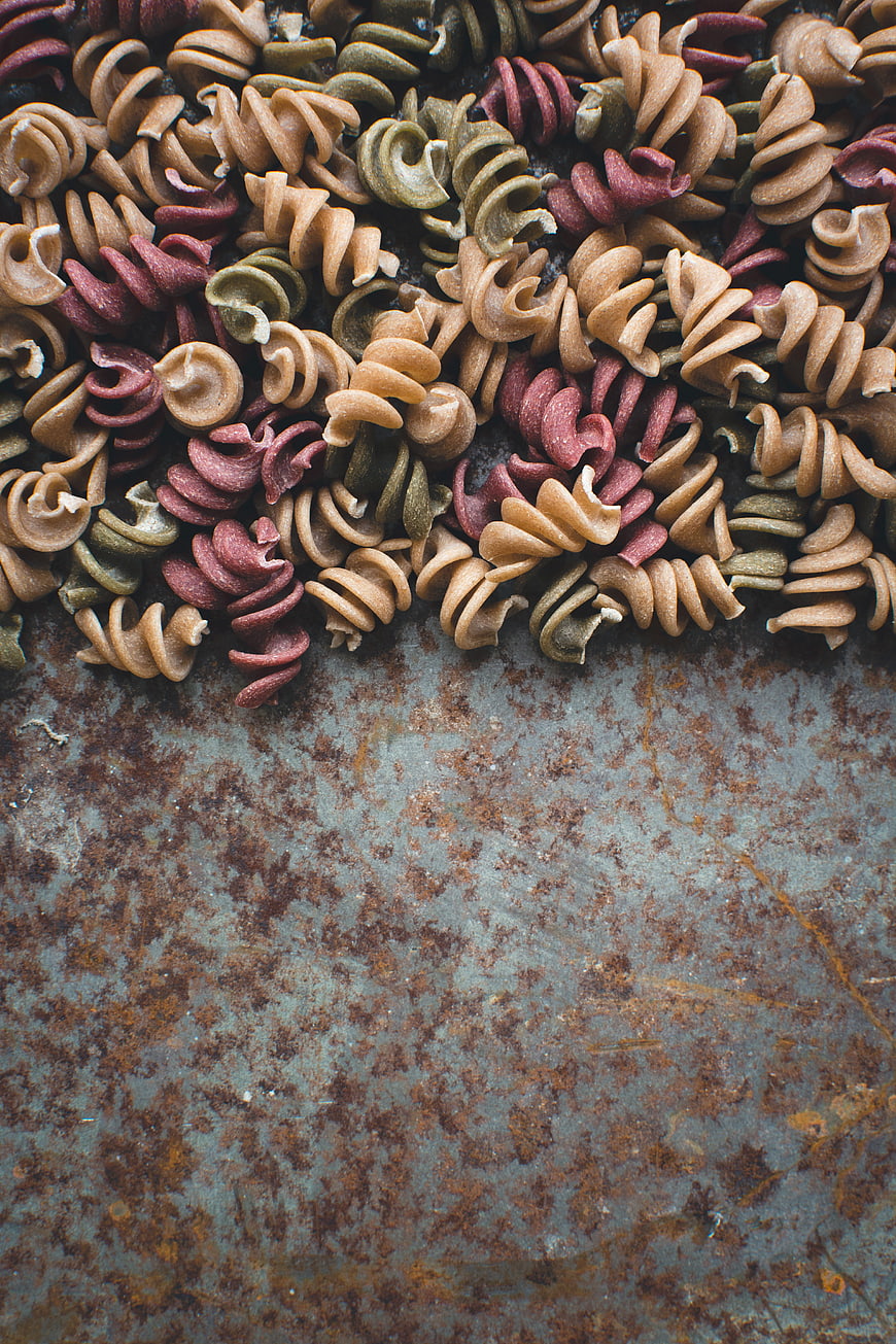 Colorful Fusilli Pasta on Rusty Metal Background