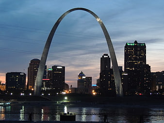 Gateway Arch and St. Louis skyline at twilight with river reflections