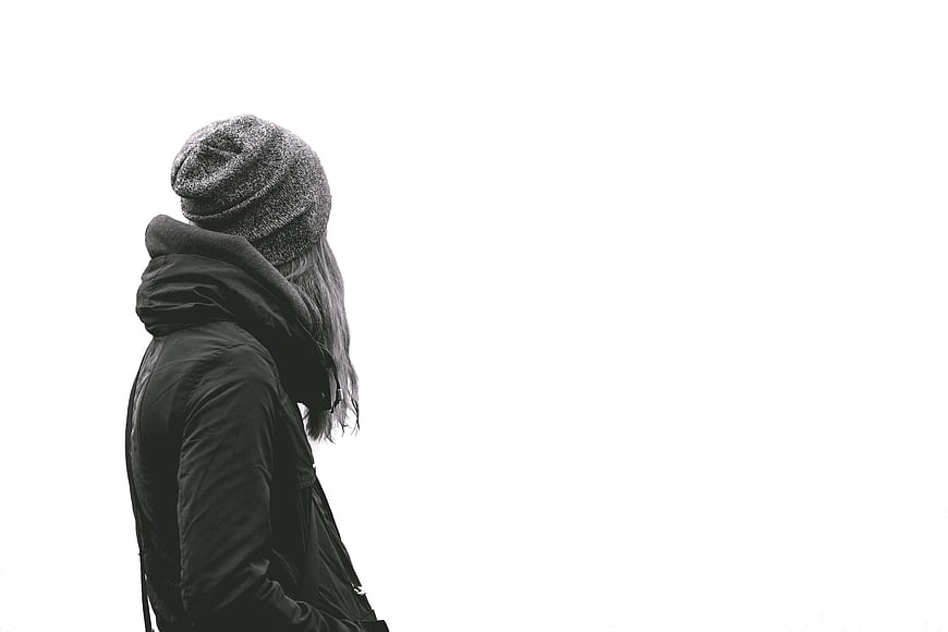 Woman in Beanie and Jacket Looking Away on White Background