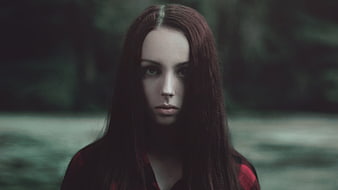 Mysterious Portrait of Woman with Dark Hair in Forest