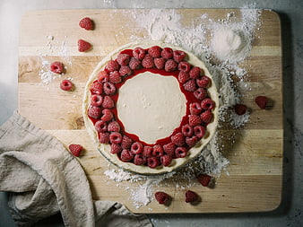 Raspberry Cheesecake on Wooden Board with Flour