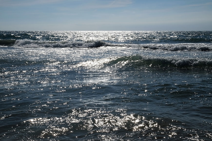 Sparkling ocean waves reflecting sunlight on a clear day