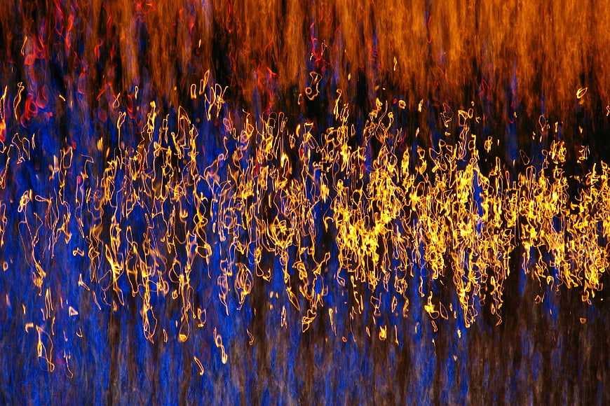 Abstract blue and gold light streaks on water texture