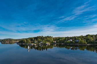 Serene Coastal Landscape with Blue Sky and Calm Water
