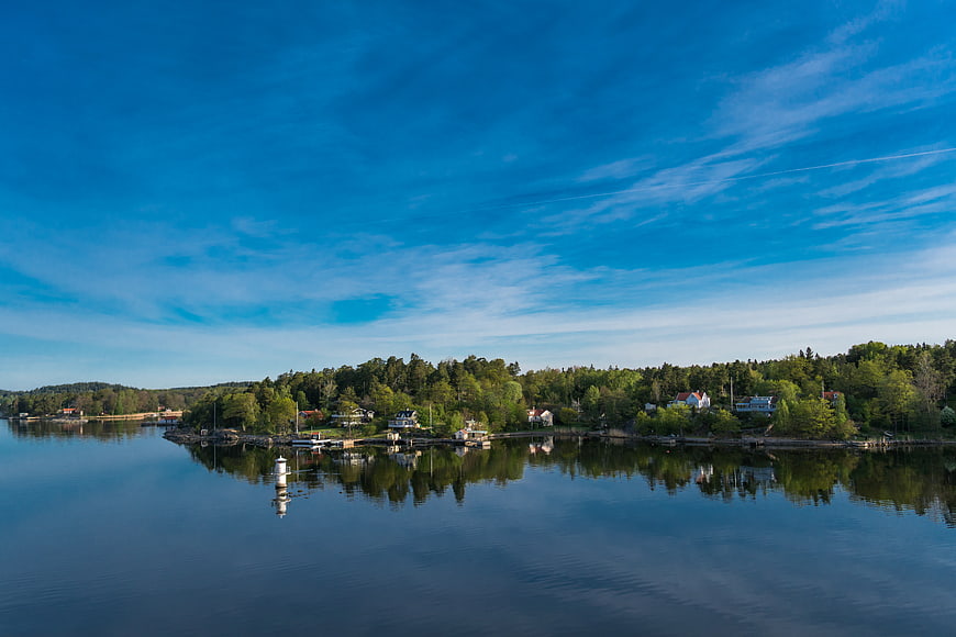 Serene Coastal Landscape with Blue Sky and Calm Water