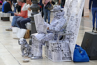 Street Performer Sculpted In Newspaper With Dog In Public Square