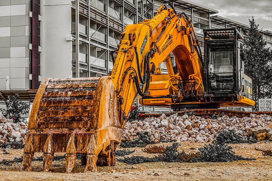 Yellow Excavator With Bucket On Construction Site