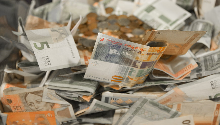 Pile of mixed European banknotes and coins