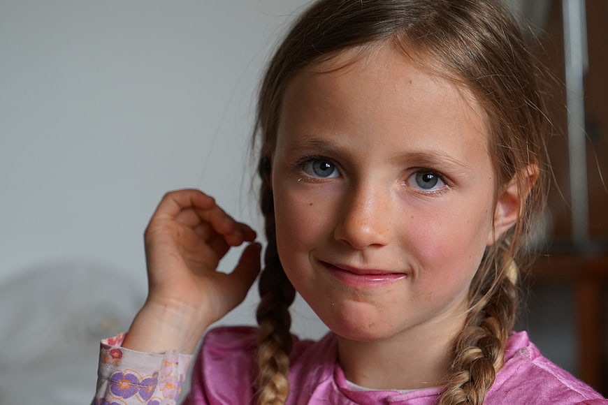 Candid Portrait of Young Girl With Braids And Gentle Smile