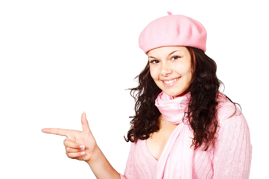 Smiling Woman in Pink Beret Pointing to Empty Space